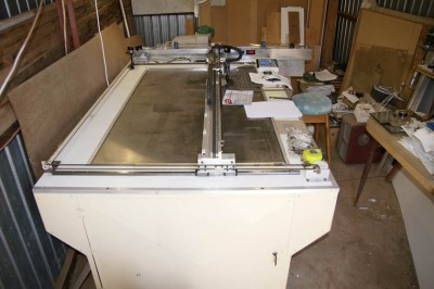Long shot of the laser table with the sheet galvo laser cover at the back for protection from dropping things on it and dust control.